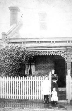 A mother and her children outside their home at 33 Danks Street, Albert Park